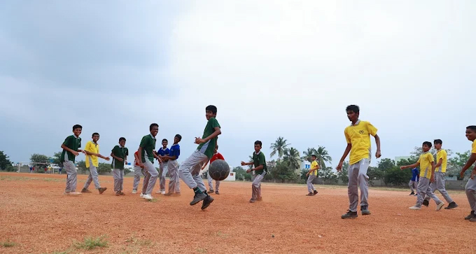 Students playing football on the school ground